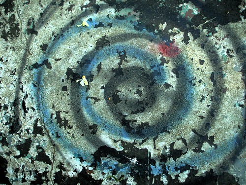 faded, scarred blue spiral graffiti
