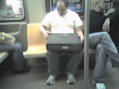 Dude Fixing A Computer In The Subway