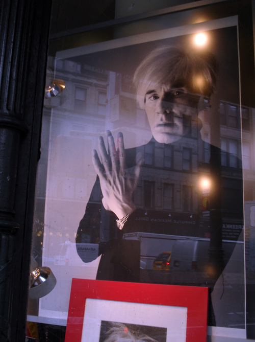 photo of Andy Warhol in window