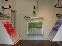 Photo of Remembrancer installation showing the three panels and robotic painters.