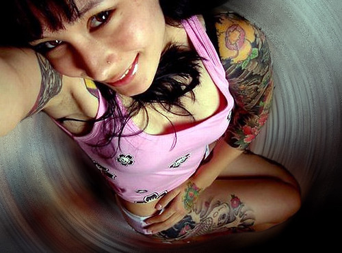 Sexy girl with many tattoos around her body