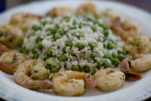 Brown Rice with Sweet Peas and Caramelized Garlic ringed by Pesto Shimp