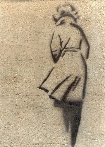 stencil graffiti: woman in a coat, walking away