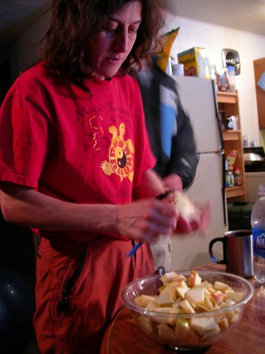 Rozz slicing apples for pie, Thanksgiving 2005 (Jesse in background)