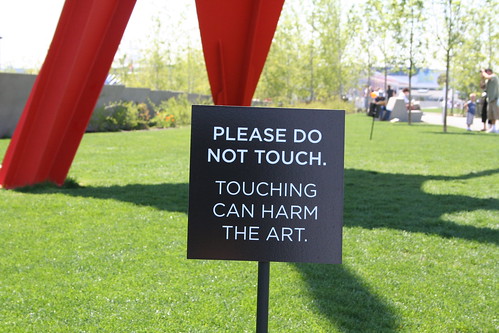 sign saying 'Please do not touch. Touching can harm the art.'