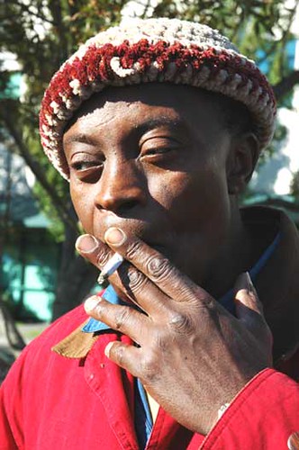 Artist Boma Cho in Seattle, Washington, at Fremont Weekly Fair, having a smoke by Wonderlane