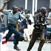 Zimbabwe: policeman and fleeing protester