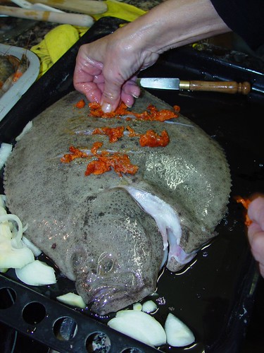 Spain: Mom stuffing a turbot with red peppers.