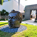 Head-like sculpture in front of Naples museum of Art entry