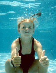 underwater girl giving a big thumbs up