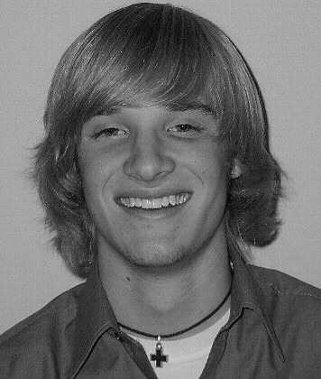 A hairstyle picture of Michael Sarver with his shaggy hair his Freshman 
