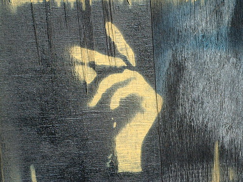 graffiti of a hand, fingers poised to snap