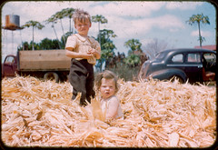 Photo from the 60s of kids sitting in corn husks