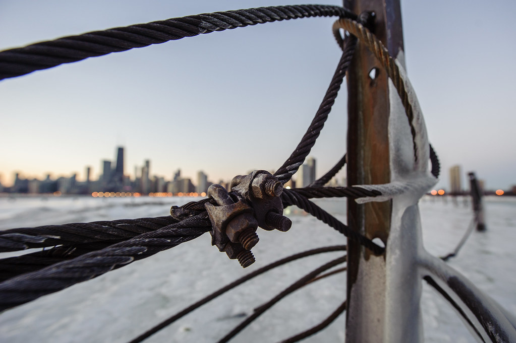 The Chicago skyline through some thick metal wire near North Ave. Beach.