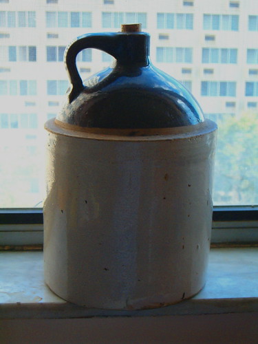 Old Moonshine Jugs. Moonshine jug in sunny window