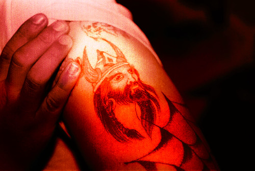 A tattoo of a Viking warrior, influenced by Norse mythology.