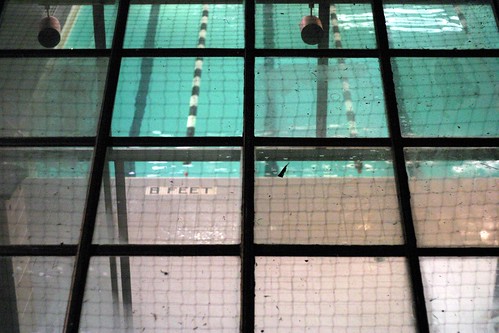 photo of a swimming pool taken through the windows above, looking down on the water and "8ft" marker on the side