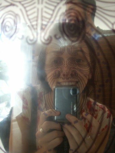 facial tattoos in a mirror reflection