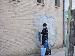 Cleaning the graffiti from Newton Food Market, 3600 12th Street NE