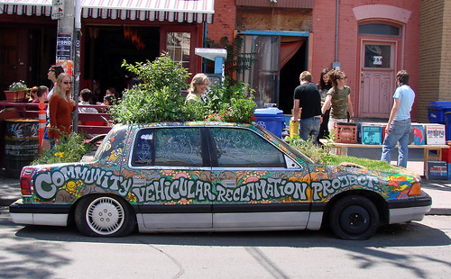 This car, in Toronto's Kensington Market, is a real planter with plants growing in it and on it!