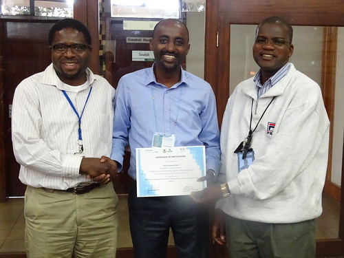 Appolinaire Djikeng, BecA-ILRI Hub Director (left) and Wellington Ekaya Senior Scientist, Capacity Building (right) present Prof Gobena Ameni with his certificate of participation