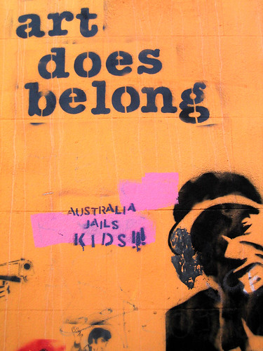 graffiti: text "art does belong" and a stencil of a person's face and then the spray-painted words, "australia jails kids"