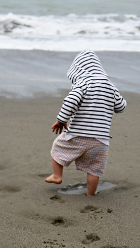 boy making footprints on the beach
