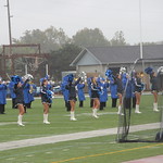 Marching band playing on football field.