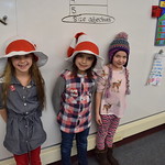 Elementary students pose in Cat in the Hat hats
