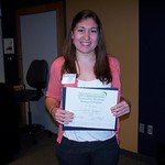 A student posing with her Honorable Mention Research Poster award.