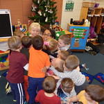 A group of preschoolers hugging a WC student