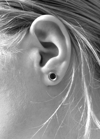 ear. ear piercings. flesh tunnel