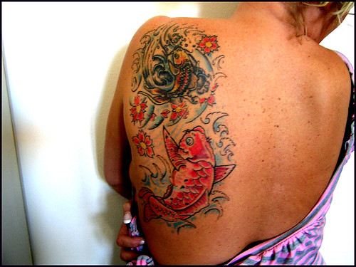 This back tattoo is stunning The Koi is a carp fish