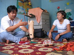 Phuong, landmine survivor and athlete in her home.