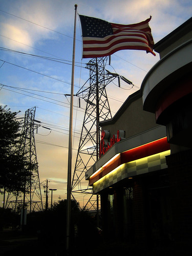 Chick-fil-A, American flag, electric lines, sunset in Austin, TX