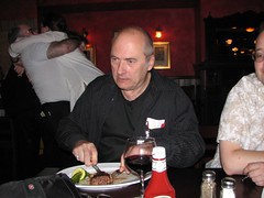 John Clute finishes Pam Zoline's dinner; people kissing in the background at Readercon