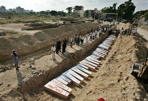 Coffins containing the bodies of Lebanese victims are laid in a mass grave in the southern Lebanon city of Tyre July 21 ap.jpg by arabist.