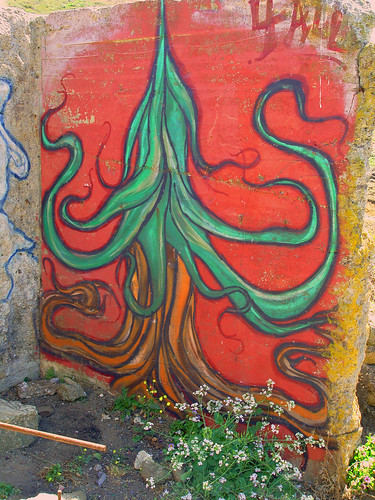 graffiti from Pacifica, CA: a flowing green tree, over flowing brown roots