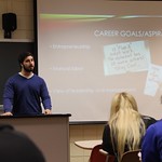 A student explaining his career goals and aspirations to fellow students in his class during a presentation.