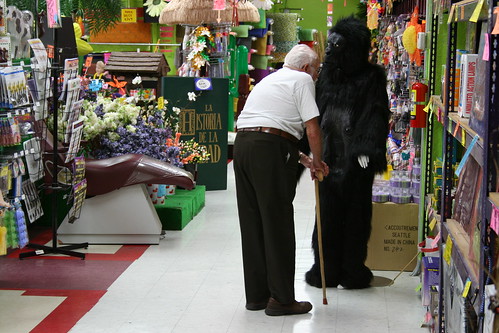 Older Gentleman Smelling Gorilla Suit
