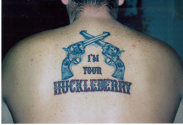 male, upper back tattoo, Somebody's a Tombstone fan.