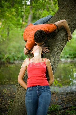 kissing photos. Couple Kissing Under Tree
