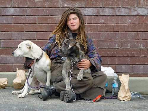 Homeless woman with dogs by Franco Folini.