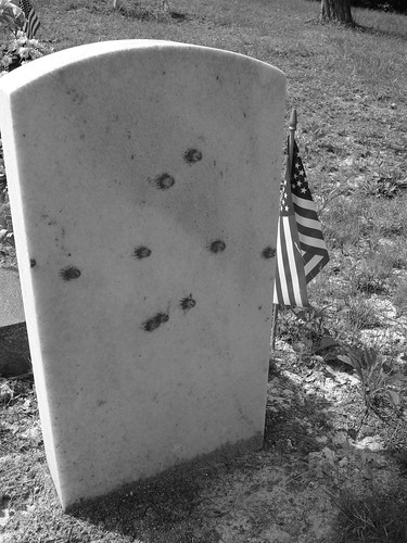 Bulletholes in one of the Stanley's gravestones.  Photo by Lucas Brown