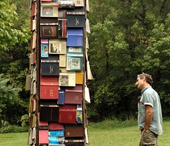 tower of books and a man interested (by zen)