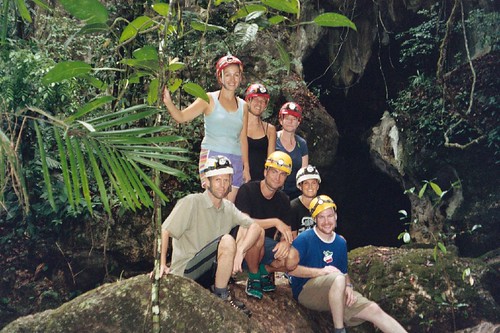 Mayawalk tour group in front of hourglass-shaped cave opening