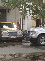 Monk cleaning a car