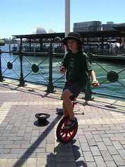 Caleb Unicycling on Circular Quay with Opera House in background