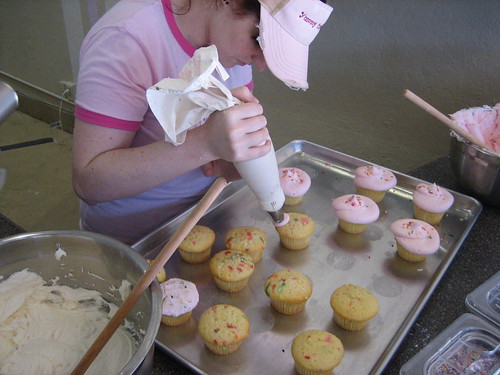 Applying frosting to Happy Cakes