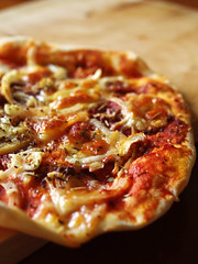 Prosciutto, anchovy and onion pizza.